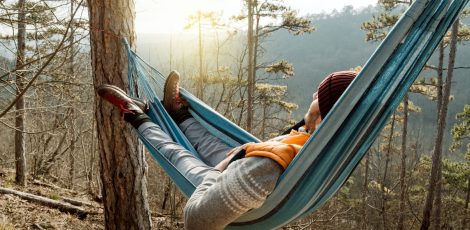 Young man resting in hammock, outdoor lifestyle